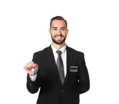 Male hotel receptionist holding room key on white background