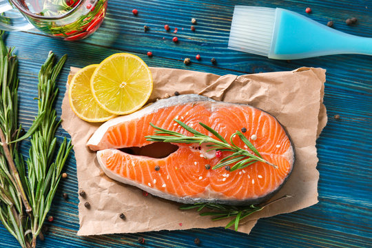 Fresh salmon steak with rosemary on paper