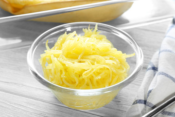 Bowl with flesh of spaghetti squash on table