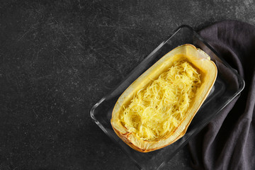 Baking dish with spaghetti squash on table