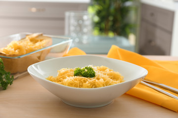 Plate with spaghetti squash on table