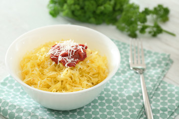 Bowl with tasty spaghetti squash on table