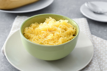 Bowl with tasty spaghetti squash on table