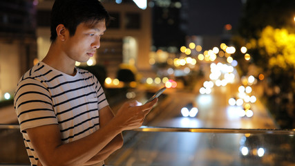 Man using cellphone at night