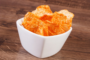 Potato crisps in bowl, concept of unhealthy food