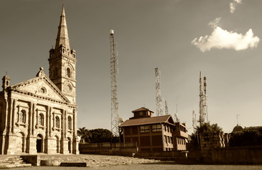 Tower of the church against the backdrop of telecommunications towers. Religion and technology.
