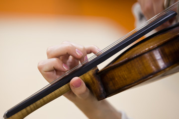Hand girl on the strings violin closeup 
