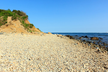 Fototapeta na wymiar Rocky beach and sand dune at Montauk Point, Long Island, New York