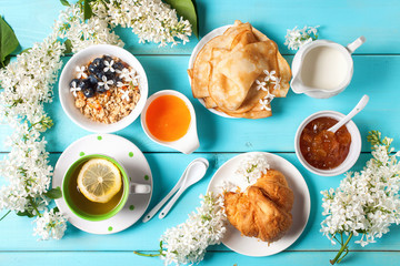 Breakfast - muesli, croissant, tea, jam, pancakes