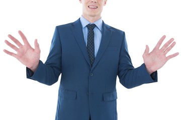 Mid section of smiling businessman using imaginary screen