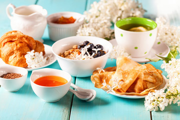 Breakfast - muesli, croissant, tea, jam, pancakes
