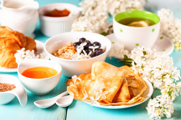 Breakfast - muesli, croissant, tea, jam, pancakes