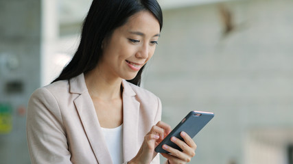 Young Business woman using cellphone in office