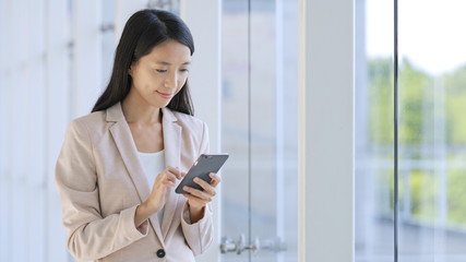 Business woman using cellphone in office