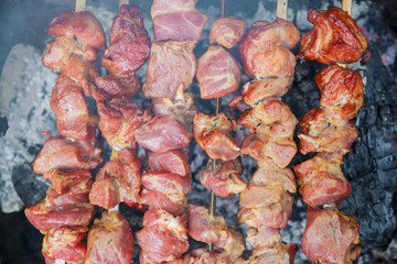 Obraz na płótnie Canvas closeup of some meat skewers being grilled barbecue