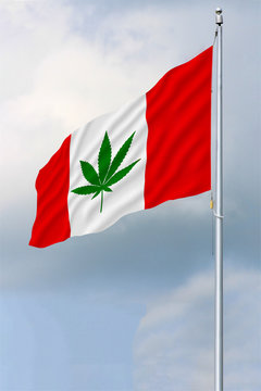 Red and white Canadian flag with a green pot leaf waving in the wind on a flagpole