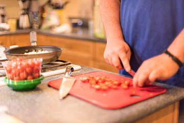 Young man preparing food in the kitchen - soft focus