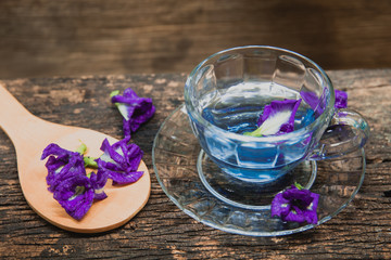 Obraz na płótnie Canvas Asian pigeonwings or Butterfly Pea Heabal hot drinking tea refresh Thai herb drink on wood background