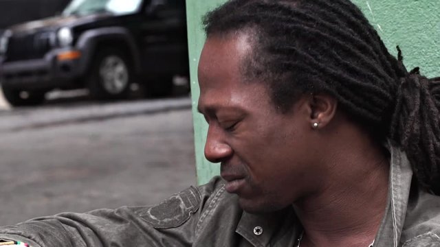 Slow motion close-up of man looking somber and downbeat