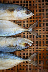 Salted mackerel on bamboo wicker background.