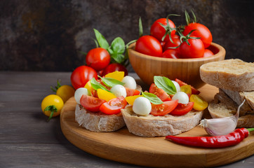 Bruschetta with cherry tomatoes and mozzarella, selective focus