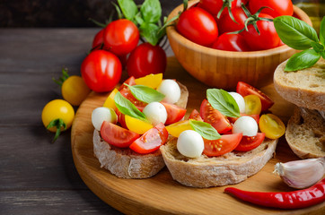 Bruschetta with cherry tomatoes and mozzarella, selective focus