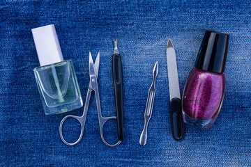 Basic set of manicure tools on jeans background