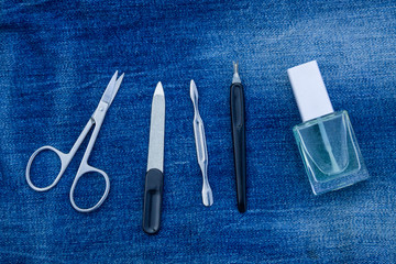 Basic set of manicure tools on jeans background