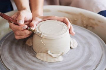 Trimming excess clay © DragonImages
