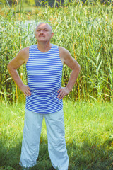 Older american man take a fitness at morning on a nature. Senior man enjoy good health lifestyle