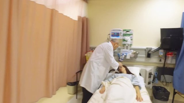 Nurse runs with a crash cart as a doctor puts an oxygen mask on a critical patient.