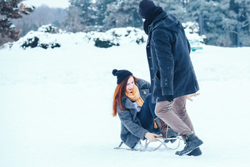 Fototapeta na wymiar young couple in love enjoying a winter vacation and having fun on a snowy winter day.