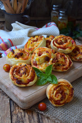 Buns of yeast dough with tomatoes, ham and cheese on a wooden background. Mini pizzas. homemade baking