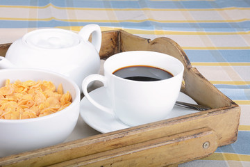 Breakfast tray with coffee and cereals.