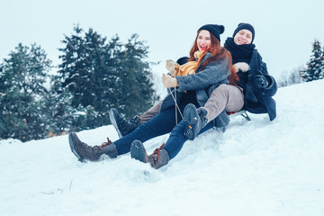 Fototapeta na wymiar young couple in love enjoying a winter vacation and having fun on a snowy winter day.