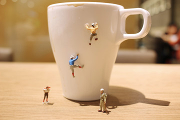 fun of mini tiny  people climbing the mug