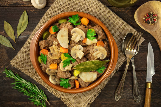 Overhead photo of meat and mushrooms ragout with herbs