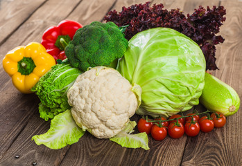 Fresh green garden cabbage on rustic wooden background. Vegetarian food. Assortment of fresh fruits and vegetables