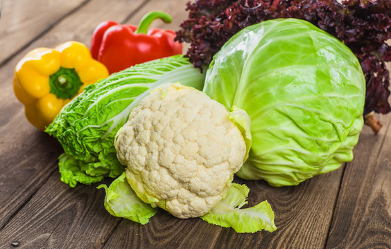 Fresh green garden cabbage on rustic wooden background. Vegetarian food. Assortment of fresh fruits and vegetables