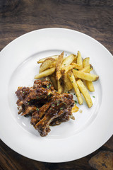 spicy bbq pork spare ribs with wedges french fries