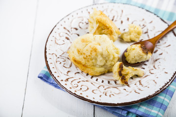 Fried cauliflower on a wooden table.