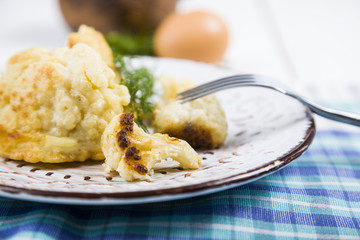 Fried cauliflower on a wooden table.