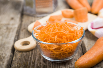 Grate  carrots in a bowl