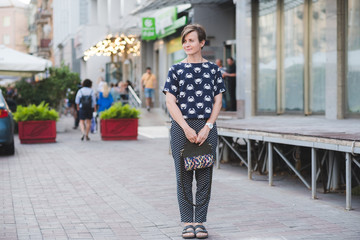 Outdoor full body portrait of young beautiful fashionable woman