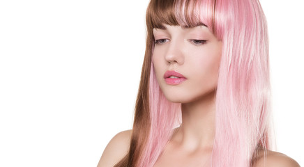 Naklejka premium Girl with a doll with pink hair. The wig is brownish-pink. Delicate, airy, natural make-up. White background.