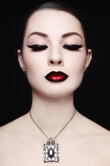 Portrait of young beautiful woman with gothic ombre lips and necklace