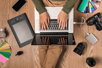 Top view of photographer at workplace with copy space