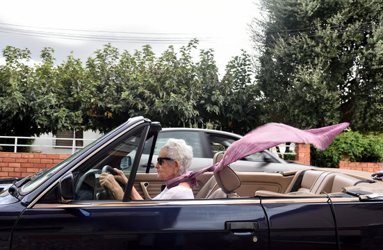 Old Woman Driving A Convertible Car