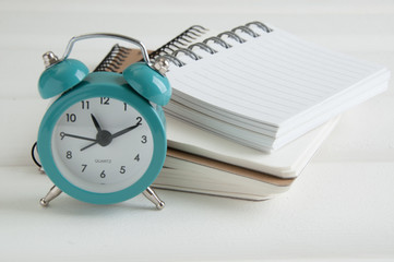 Turquoise alarm clock on white