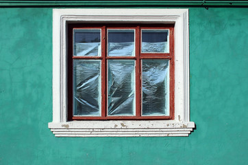 Decorative window on the turquoise wall.